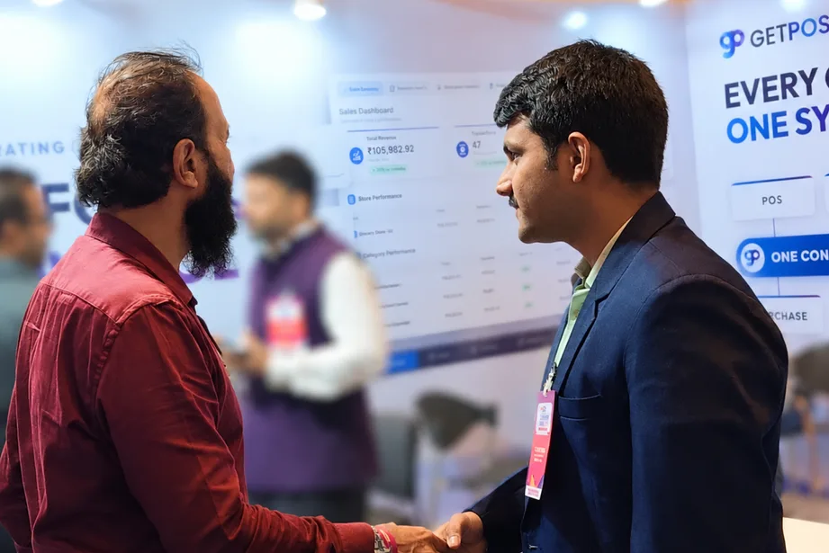 Handshake with a visitor at the GETPOS booth